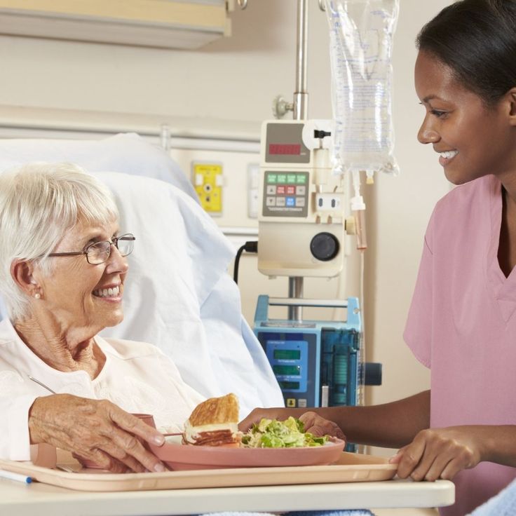 Smiling caregiver and senior client enjoying conversation together
